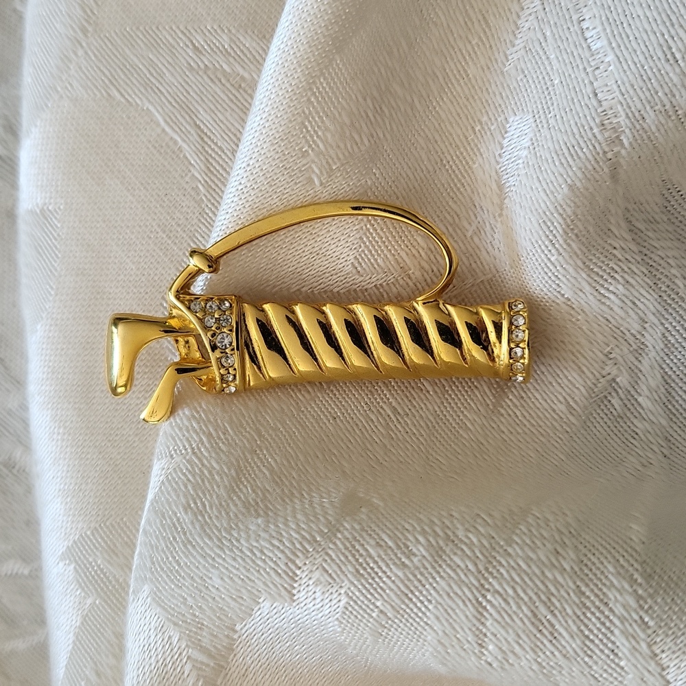 Golf pin. Gold-tone with faux- diamond like stones. Excellent condition.